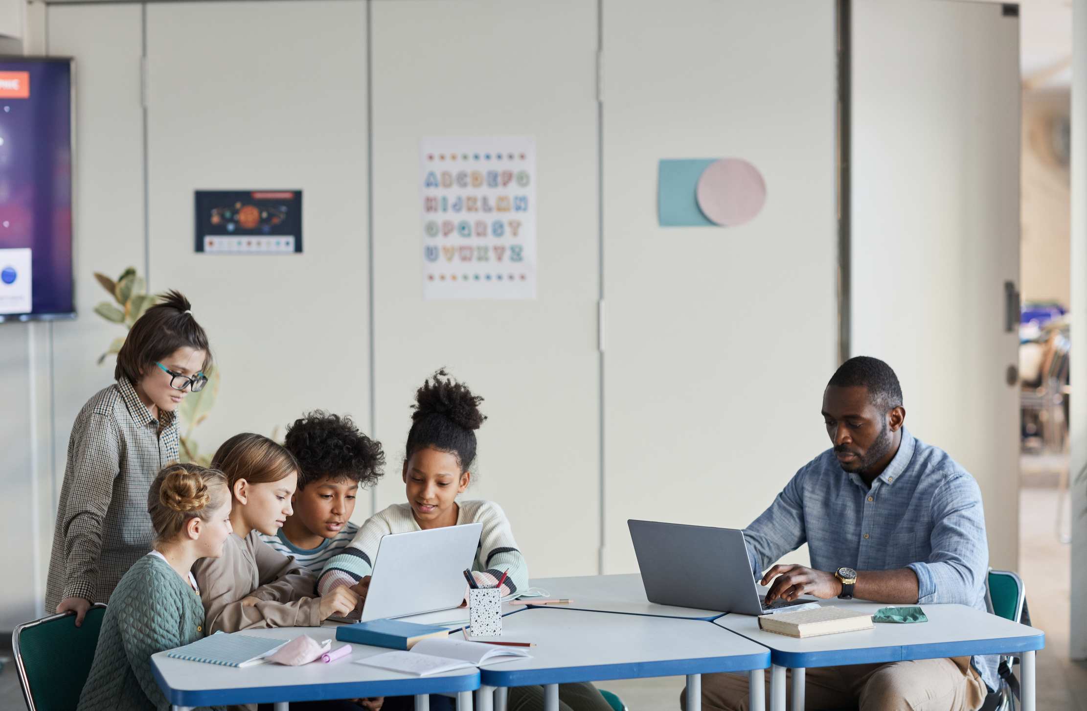 Students and teacher working together in a modern classroom